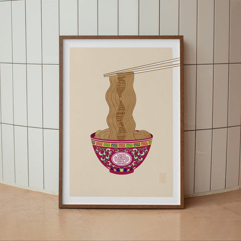 Framed artwork of a bowl with noodles against a tiled wall.